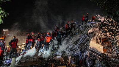 Rescue workers and people search for survivors at a collapsed building after a 7.0 magnitude earthquake in the Aegean Sea, at Bayrakli district in Izmir, Turkey. EPA