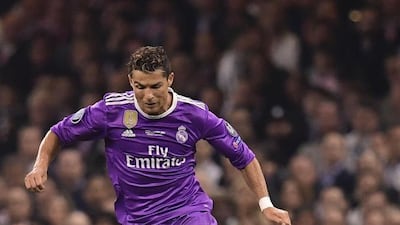 Juventus’ Colombian midfielder Juan Cuadrado, right, tackles Real Madrid’s Portuguese striker Cristiano Ronaldo. Javier Soriano / AFP