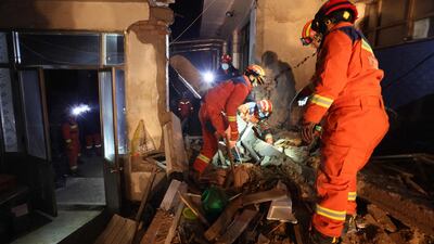 Rescuers search a house for survivors in Kangdiao village. AFP