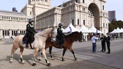 Police on horseback patrol outside a vaccination centre in Melbourne, Australia, ahead of an anti-vaccination protest. Lockdown in the city has been extended for another week. AFP