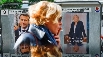 Posters for French presidential election candidates Marine le Pen, leader of French far-right National Rally party, and French President Emmanuel Macron, candidate for re-election, on an official billboard in Paris, France. Reuters