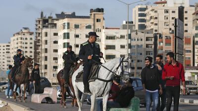 Palestinian mounted policemen instruct people at the Gaza beachfront to return home as part of measures to stem the spread of the Covid-19 pandemic. AFP