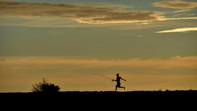A fisherman walks at sunset at Lhoknga beach in Aceh province. AFP