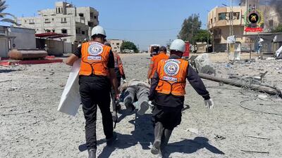 Rescuers carry an injured person on a stretcher in Khan Younis. Reuters