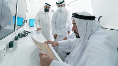 Sheikh Dr Sultan looks at a visual representation of the area surrounding the heritage sites.