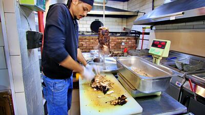 Abed chops the freshly cooked meat. Courtesy Charlie Faulkner