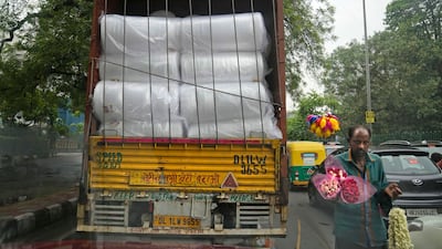 A lorry carries rolls of plastic used in packaging in New Delhi. AP
