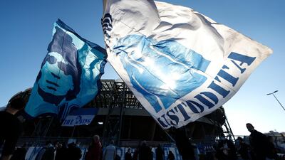 People wave Diego Maradona flags outside the Stadio San Paolo in Naples. Reuters