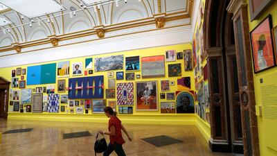 A member of the Royal Academy of Arts staff walks into one of the galleries displaying artworks of 250th Summer Exhibition. Peter Nicholls / Reuters