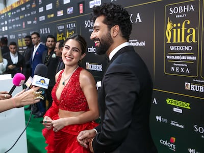 Vicky Kaushal, right, and Sara Ali Khan arrive on the green carpet at the IIFA Awards 2023 in Abu Dhabi. Victor Besa / The National