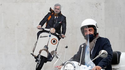 A man drives past a mural depicting new AS Roma coach Jose Mourinho riding a Vespa on a wall in Rome. Reuters