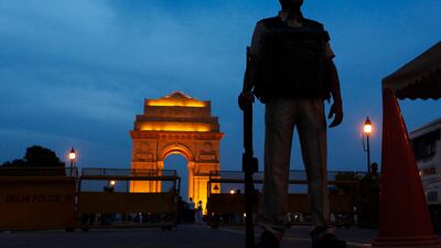 July 14 2011: A policeman stands guard with the backdrop of the India Gate war memorial, a popular tourist place, in New Delhi, India. Security across India is on high alert following the explosions in Mumbai on Wednesday. AP Photo/Gurinder Osan