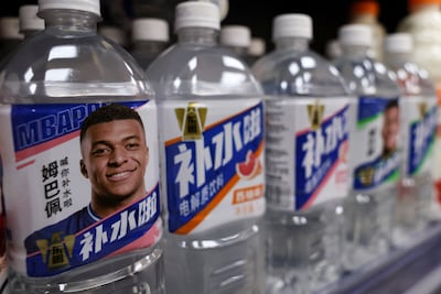 Bottled drinks by Eastroc Beverage with images of Kylian Mbappe are displayed on a shelf at a store, in Beijing, China. Reuters