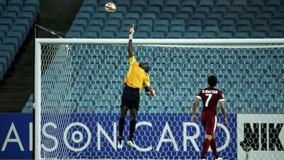 Qatar goalkeeper Qasem Burhan fails to stop Sayed Ahmed's long-range chip during their Asian Cup Group C match. Jason Reed/Reuters