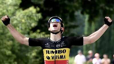 Team Jumbo Visma's Wout van Aert celebrates as he crosses the finish line to win Stage 11.