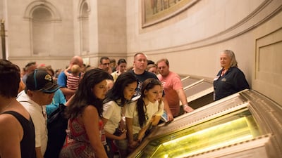 Visitors read the US Constitution on display at the National Archives in Washington.