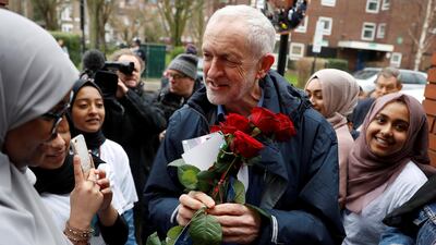 Britain's opposition Labour Party leader, Jeremy Corbyn, is greeted by young women and red roses during a visit to Finsbury Park Mosque, on Visit My Mosque day, in London. Reuters
