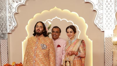 Groom Anant Ambani with his parents Mukesh and Nita on the day of his wedding. Reuters