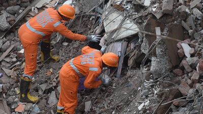 Rescue workers search for survivors in the rubble of a collapsed five-storey apartment building in Mahad, a town about 170 kilometres south of India's financial capital Mumbai. AFP