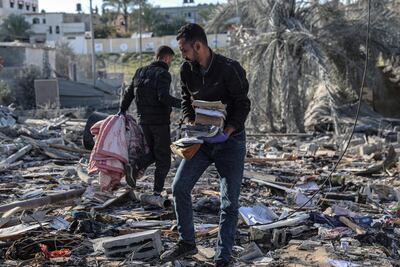 Palestinians search for their belongings amid the rubble of houses destroyed by Israeli bombs in Rafah. AFP