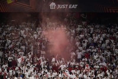 Sevilla's supporters light flares at the end of the UEFA Europa league quarter final second Leg victory over Manchester United. AFP