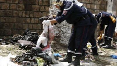 A rescuer clears the site of a suicide bomb attack in Issers, which killed 43 people and wounded 38 today.