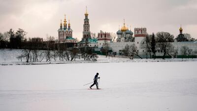 A skier moves on a frozen pond near Novodevichy Monastery on a snowy day in Moscow. AFP