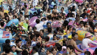 Holidaymakers jostle at a Toshimaen Amusement Park pool in Tokyo, Japan, 2 August 2014. EPA