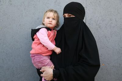 A woman holds a baby at the Syrian Centre for Countering Extremist Ideology in the Syrian town of Marea, in the northern Aleppo district, on November 30, 2017. Nazeer Al Khatib / AFP