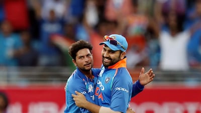 Kuldeep Yadav, left, celebrates after taking his second wicket of the match - that of Pakistan captain Sarfraz Ahmed. Chris Whiteoak / The National