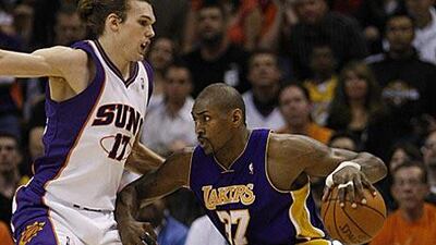 The Lakers' Ron Artest, right, tries to drive past the Suns' Louis Amundson as Los Angeles powered their way to a 102-96 win.