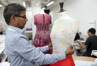 Rami Al Ali & Karashash Nurakhmet's team busy at work. Chris Whiteoak / The National