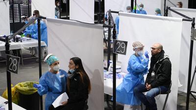 Health workers collect swab samples for rapid antigen tests for Covid-19 from people who will attend a rock music concert in Barcelona, Spain. AFP