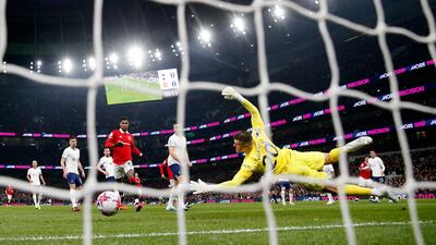 Manchester United's Jadon Sancho scores past Tottenham Hotspur's Fraser Forster. Reuters