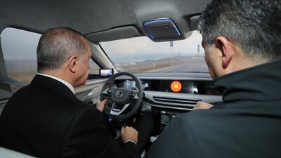 Turkish President Recep Tayyip Erdogan test drives the TOGG prototype, in Kocaeli, Turkey. EPA