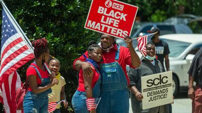 Mourners listen to the service outside of Ebenezer Baptist Church in Atlanta. Reuters