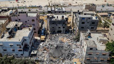 Palestinians search through the rubble of a building hit by an Israeli air strike in Gaza city. AP