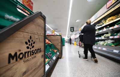 A customer shops at Morrison's supermarket in London. Some politicians have raised concerns that a private equity buyout could cut jobs and sell off large chunks of the grocer's real estate portfolio. EPA