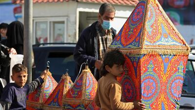 People shop for traditional lanterns to extend Ramadan greetings at the main market in Gaza City. AP Photo