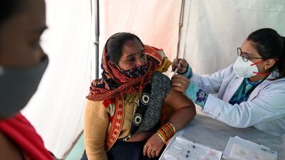 A woman gets herself inoculated with the Covishield Covid-19 vaccine at a railway station in New Delhi. AFP