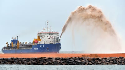A dredger pumps sand to reclaim land just outside a port in the Sri Lankan capital Colombo on September 6, 2017, as part of a USD 1.4-billion real estate development by China - an example of the sort of project that is leading to a global shortage of sand. Ishara S.Kodikara / AFP