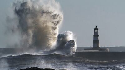 Waves crash against the lighthouse in Seaham Harbour, County Durham on January 31. PA