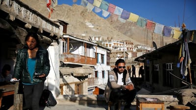 Travel agent, Stanton Othsil, 29, sits in the sun in Leh. When asked how living in the world's fastest growing major economy had affected life, Othsil said: "More tourists are coming now, especially Indians who are spending more money."