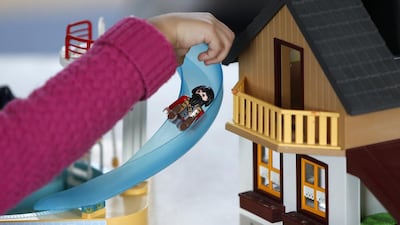 A child plays with a Playmobil figure at the Playmobil FunPark, adjacent to the Playmobil Malta factory. Darrin Zammit / Reuters