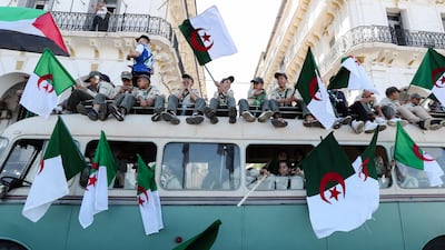 Algerian scouts wave national flags during a parade in Algiers ahead of the country's Independence Day. EPA