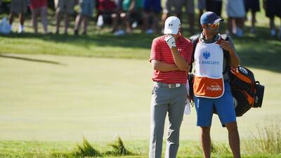 Jordan Spieth of the United States waits on the 12th hole with his caddie Michael Greller during the second round of The Barclays at Plainfield Country Club on August 28, 2015 in Edison, New Jersey. Ross Kinnaird/Getty Images/AFP