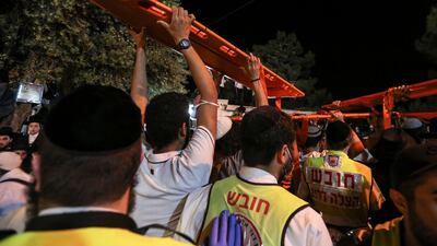 Medics and rescue workers carry stretchers at the Lag BaOmer event in Mount Meron, northern Israel, where fatalities were reported among thousands of ultra-Orthodox Jews gathered at the tomb of a 2nd-century sage for annual commemorations that include all-night prayer and dance. Reuters