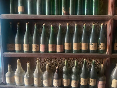 The shop is full of old, empty glass bottles with handwritten slips, a sign of better times. Photo: Safina Nabi