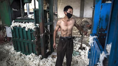 A worker uses a machine to bag sheep’s wool imported from Australia after it was processed and bleached. Kevin Frayer / Getty Images