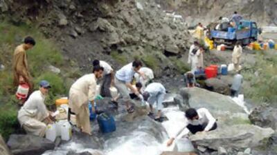 Victims collect clean water from mountains after floods destroyed much of the water supply infrastructure in Chitral.